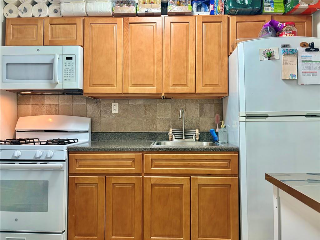 262 72nd Street Brooklyn, NY 11209 - Photo 3 of 5 a kitchen with stainless steel appliances granite countertop a refrigerator and a stove top oven
