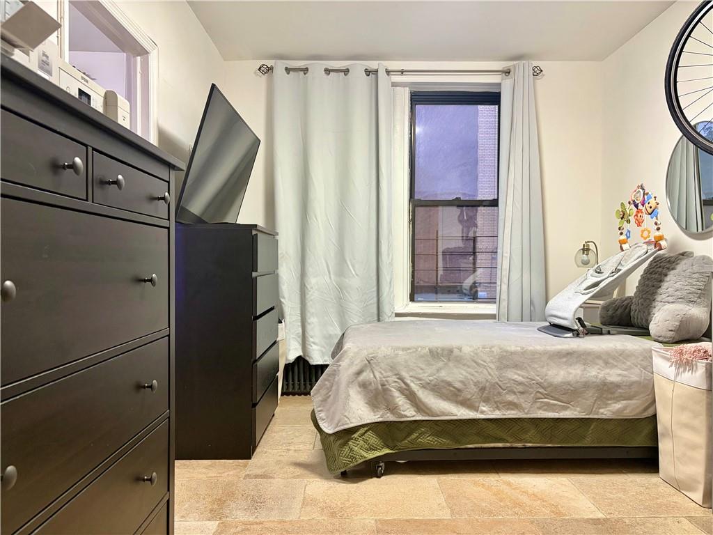 262 72nd Street Brooklyn, NY 11209 - Photo 4 of 5 a bedroom with a bed and a mirror