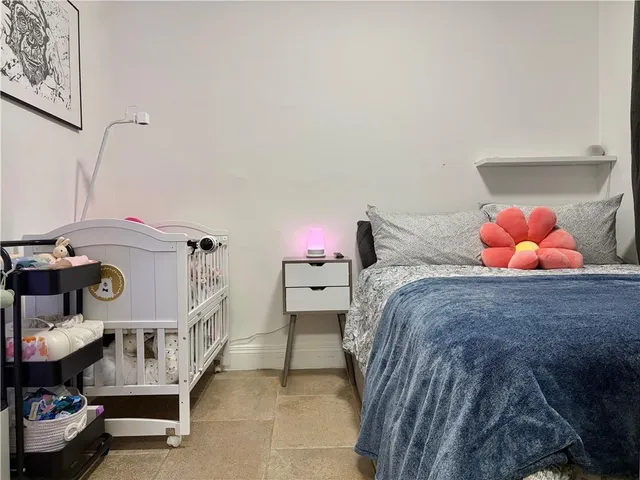 a bed room with a bed and two chairs