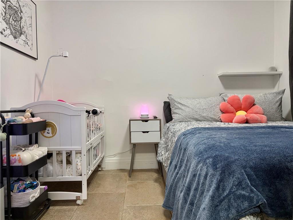 262 72nd Street Brooklyn, NY 11209 - Photo 5 of 5 a bed room with a bed and two chairs