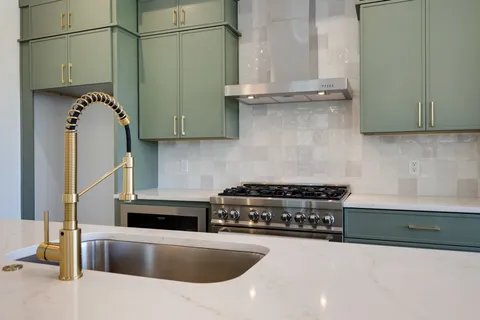 a kitchen with a sink a stove and a refrigerator