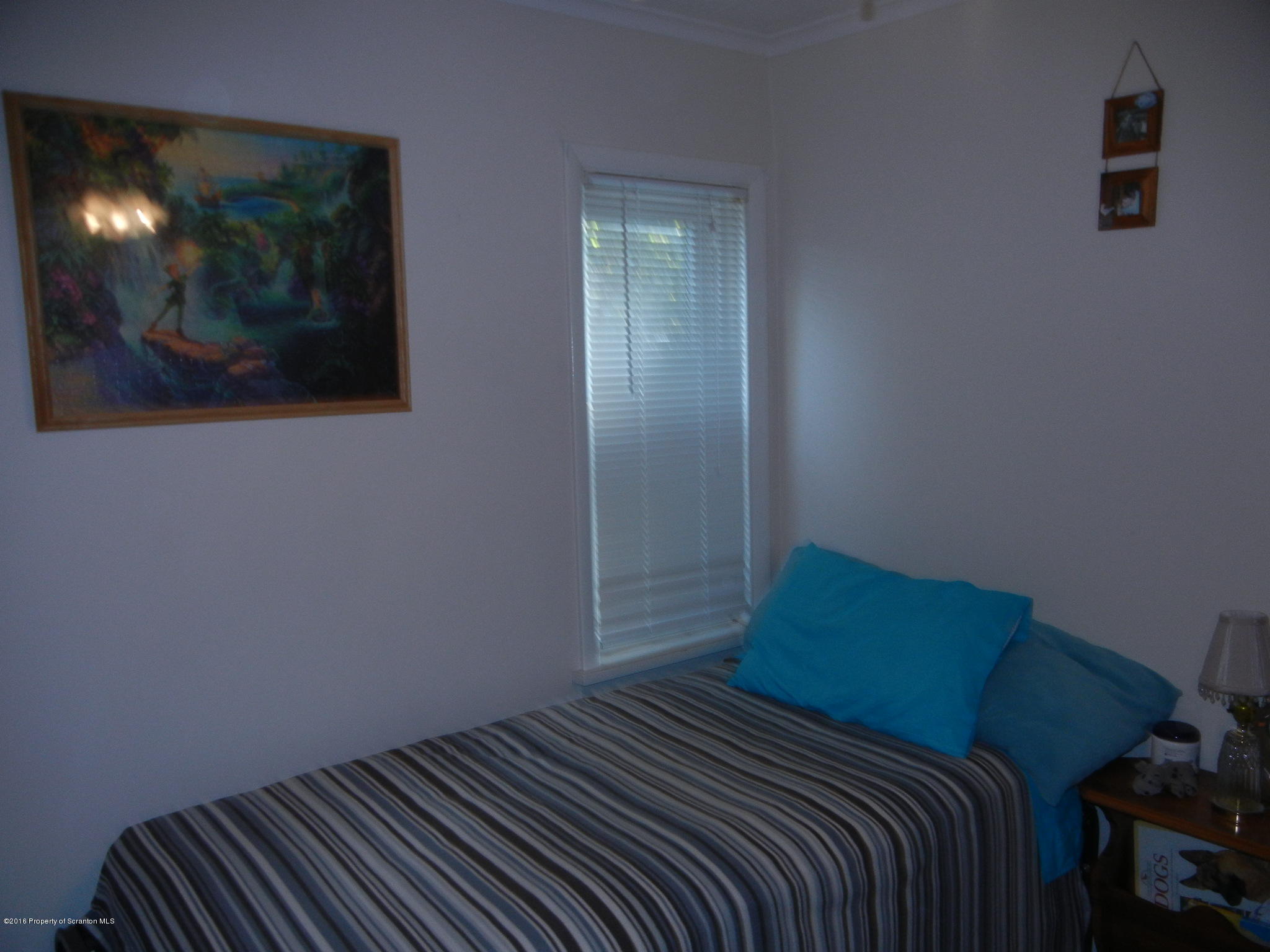2024 Rigg Street Dunmore, PA 18512 - Photo 23 of 28 a bedroom with a bed and mirror