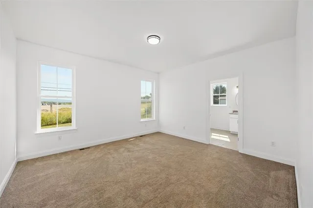 an empty room with windows and closet