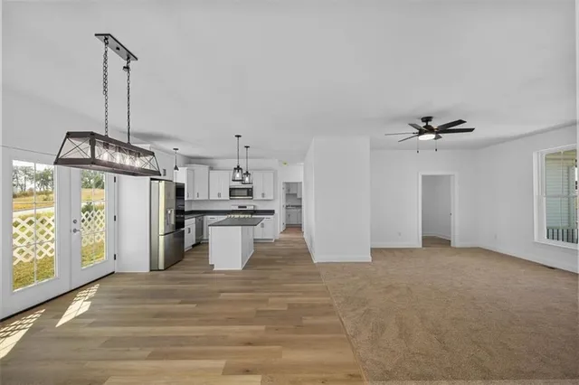 a view of a kitchen with a sink and refrigerator
