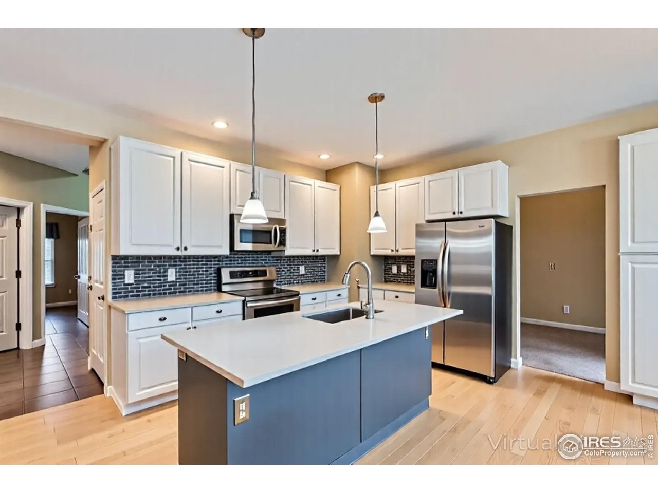 2834 Blue Jay Way Lafayette, CO 80026 - Photo 11 of 47 a kitchen with refrigerator cabinets and wooden floor