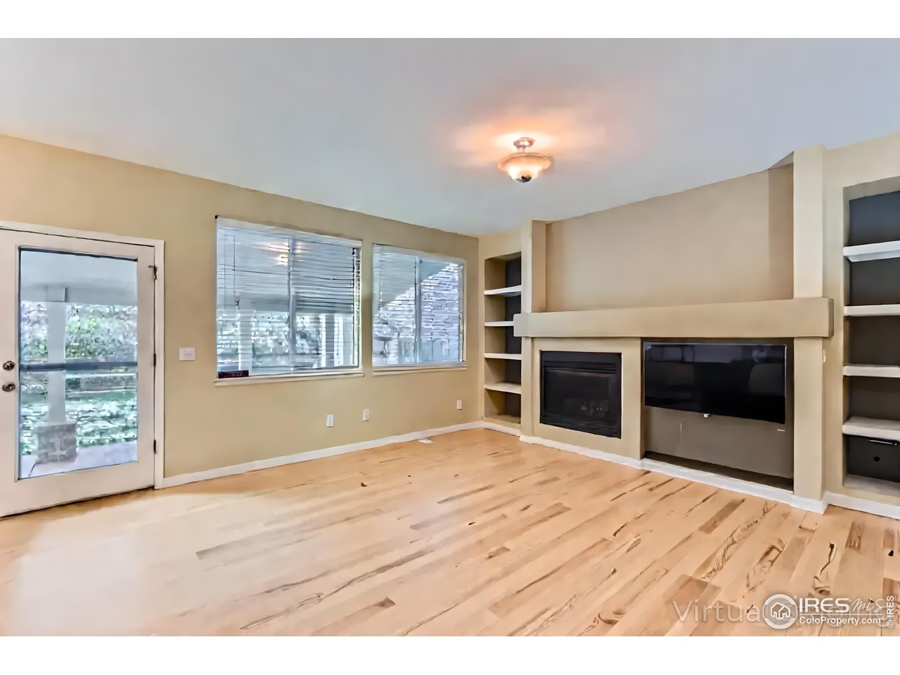 2834 Blue Jay Way Lafayette, CO 80026 - Photo 15 of 47 a view of an empty room with a window and fireplace