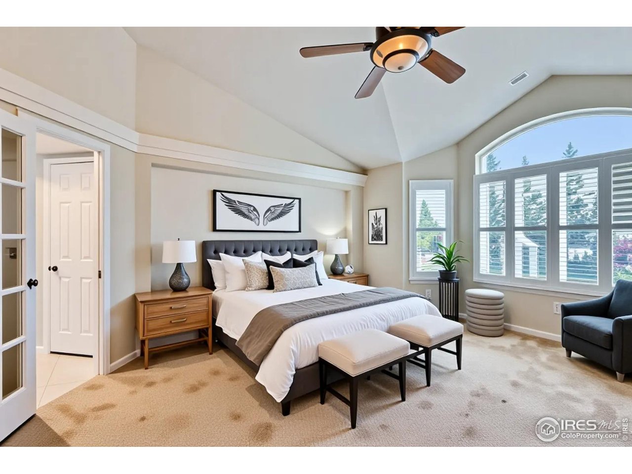 2834 Blue Jay Way Lafayette, CO 80026 - Photo 18 of 47 a bedroom with a bed and a chandelier