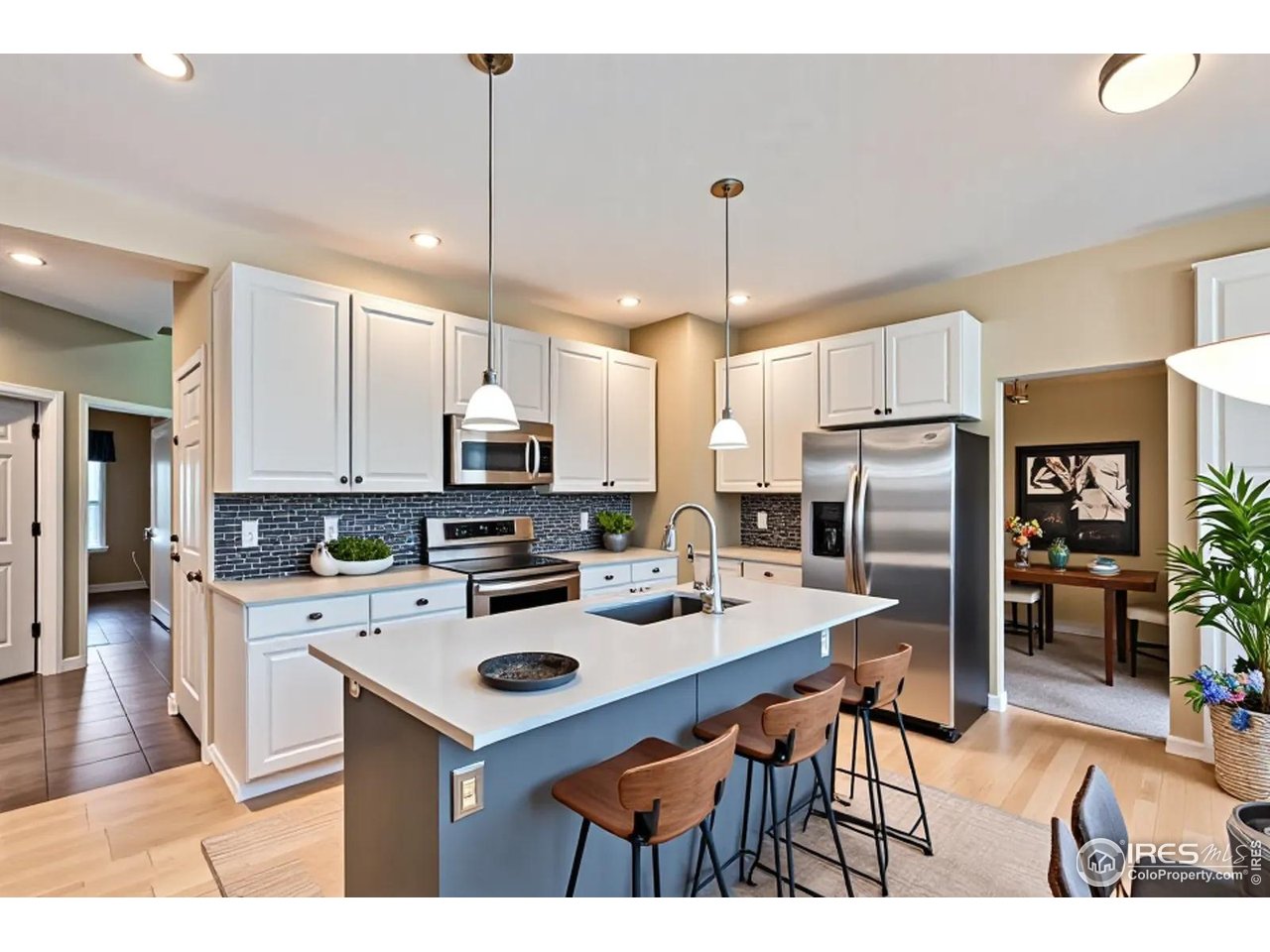 2834 Blue Jay Way Lafayette, CO 80026 - Photo 10 of 47 a kitchen with stainless steel appliances a stove a sink a refrigerator a center island and chairs