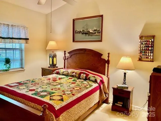 a bed sitting in a bedroom next to a lamp