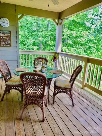 a view of a chairs and table in the balcony