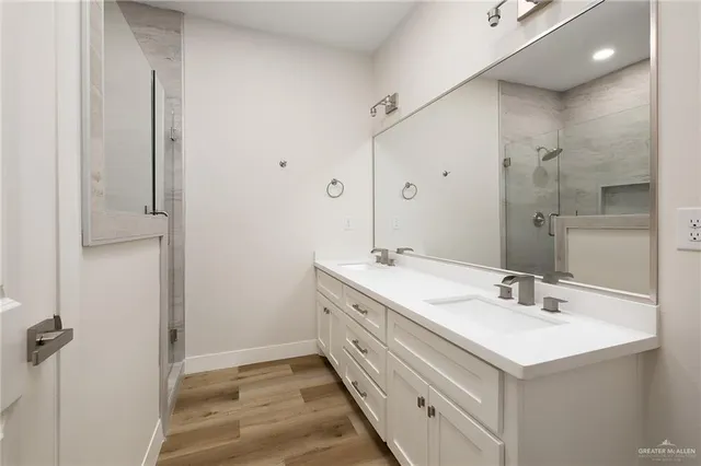 a bathroom with a sink double vanity and a mirror