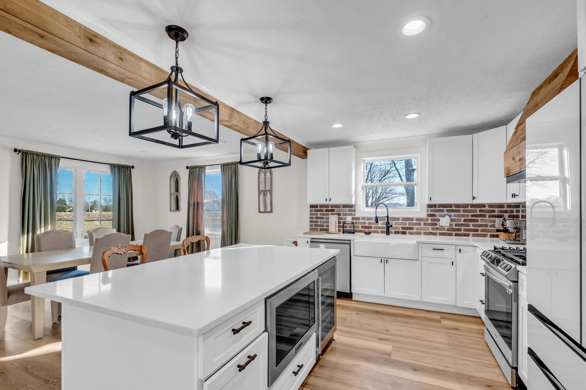 1447 Maxwell Branch Road Cottontown, TN 37048 - Photo 11 of 55 a kitchen with a sink stainless steel appliances cabinets and a counter top space