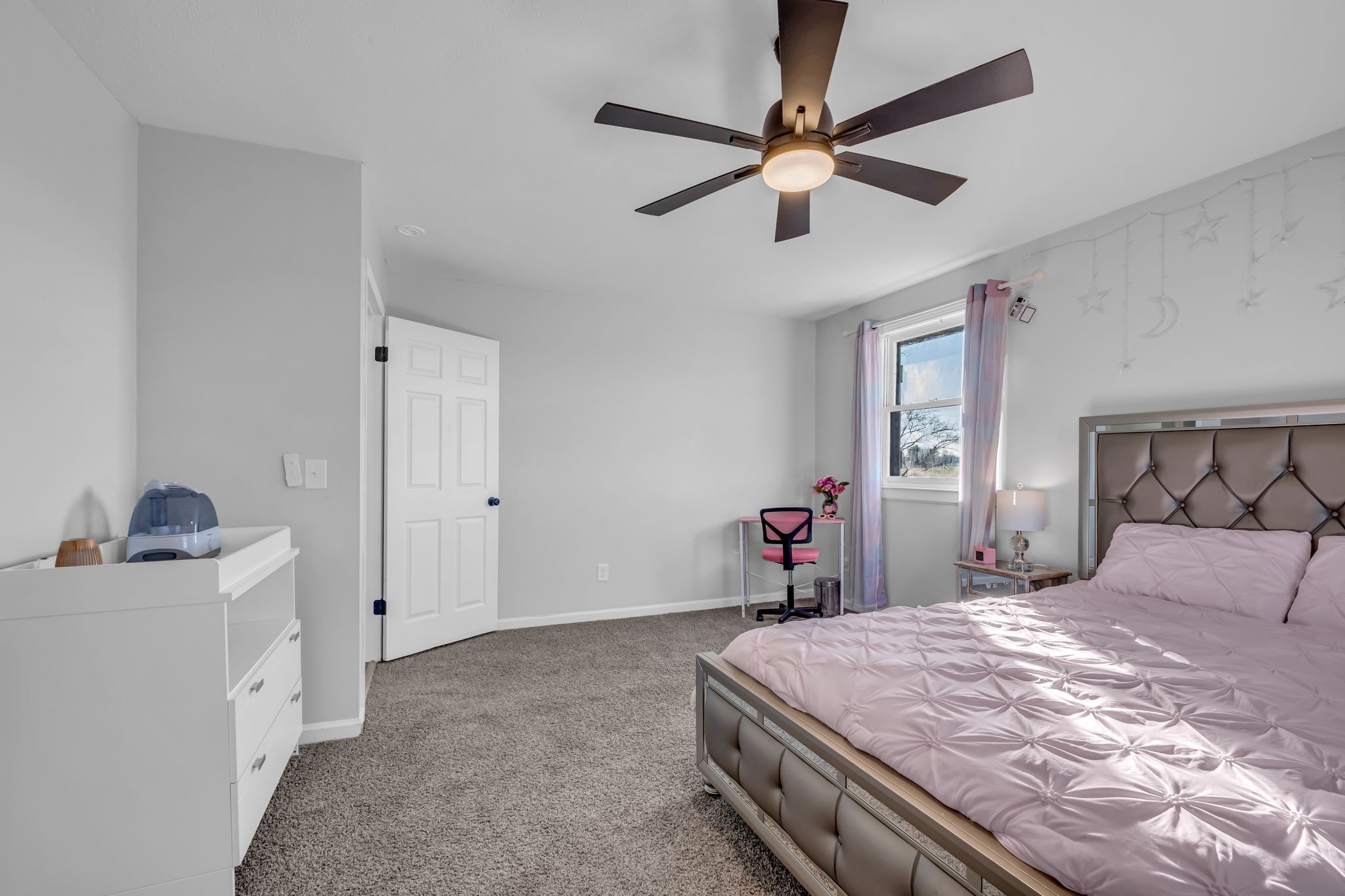 1447 Maxwell Branch Road Cottontown, TN 37048 - Photo 17 of 55 a bedroom with a bed and a chandelier