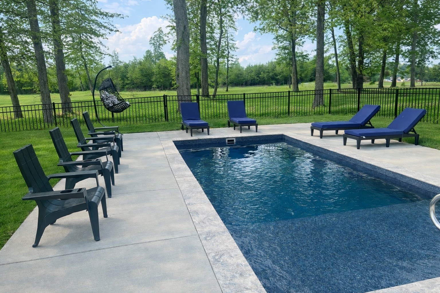 1447 Maxwell Branch Road Cottontown, TN 37048 - Photo 51 of 55 a view of a swimming pool and lounge chairs in back yard