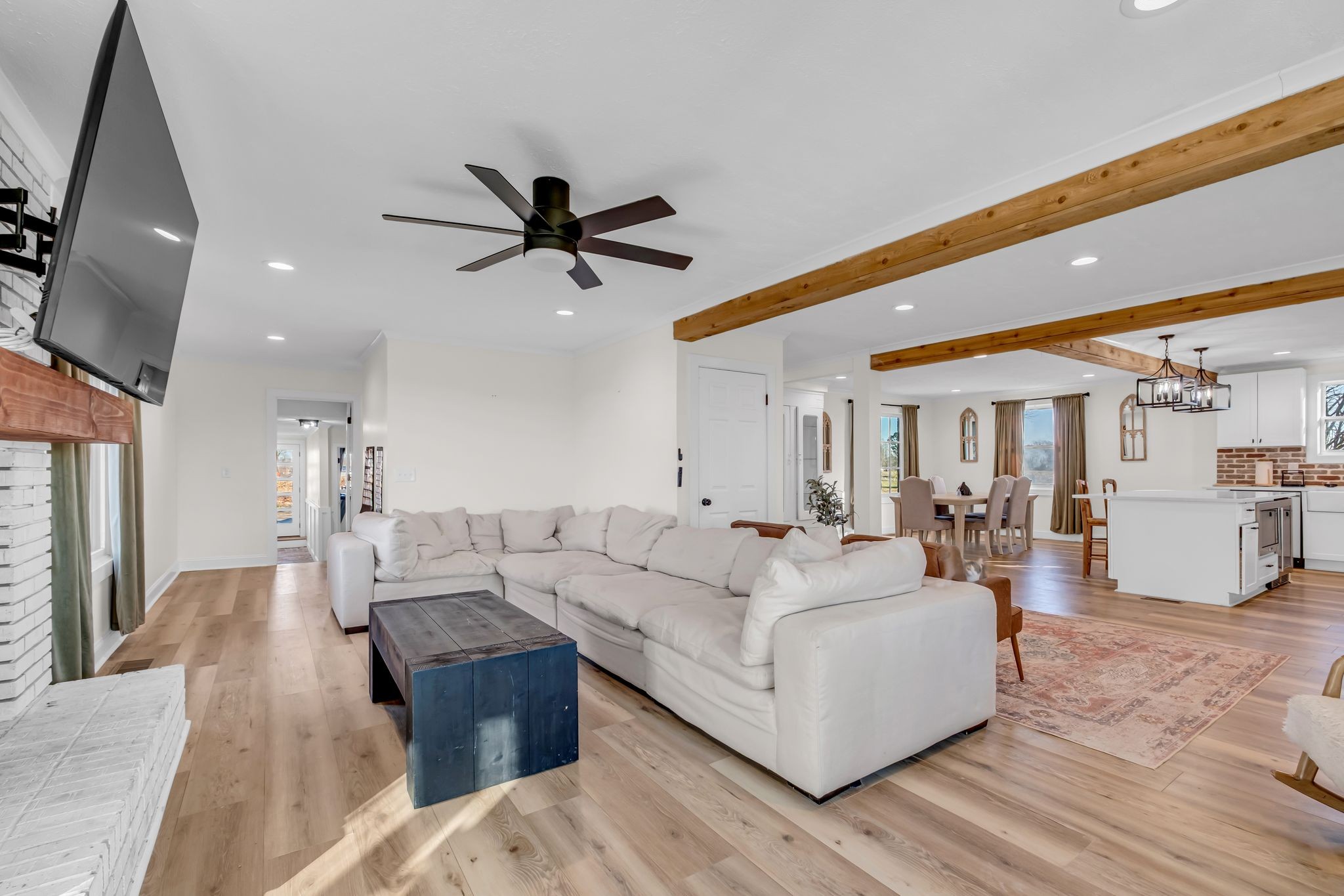 1447 Maxwell Branch Road Cottontown, TN 37048 - Photo 6 of 55 a large living room with furniture and a chandelier