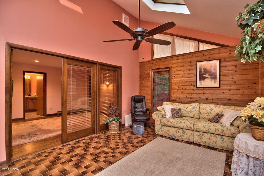 3042 Northgate Road Lake Ariel, PA 18436 - Photo 25 of 37 a balcony view with a couch and wooden floor