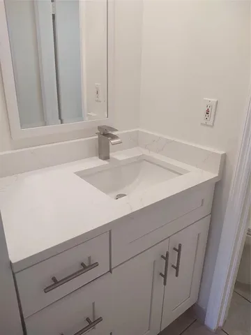 an empty room with wooden floor and window