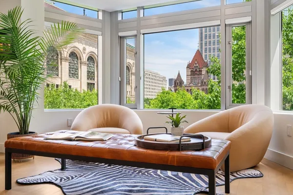 a living room with a couch and a floor to ceiling window