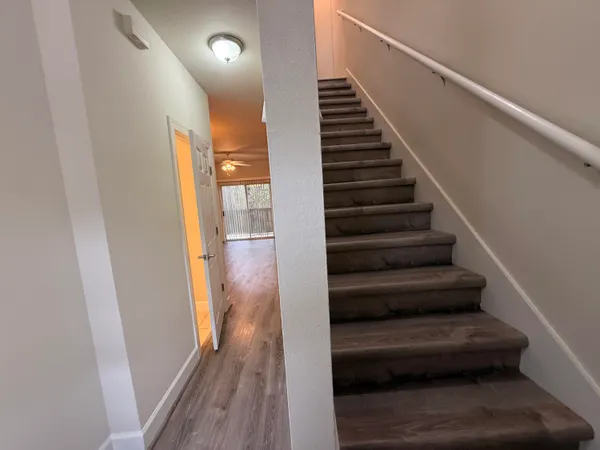 a view of entryway and hall with wooden floor