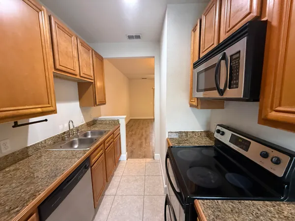 a kitchen with a sink stove and cabinets
