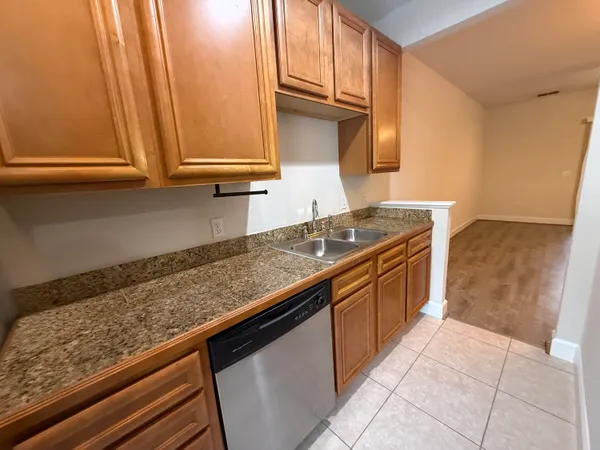 a kitchen with granite countertop a sink and a stove