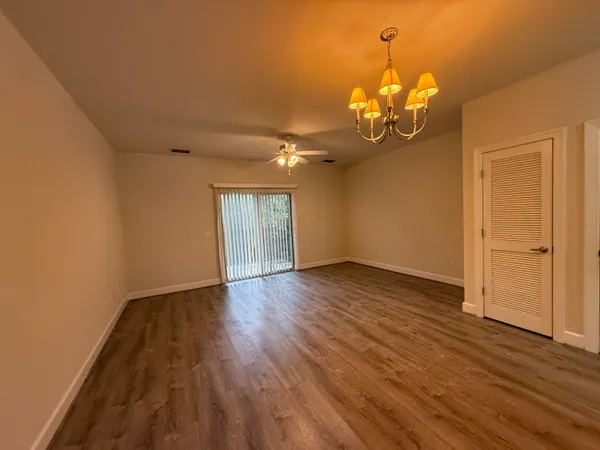 a view of a room with wooden floor