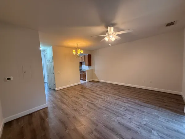 a view of empty room with wooden floor