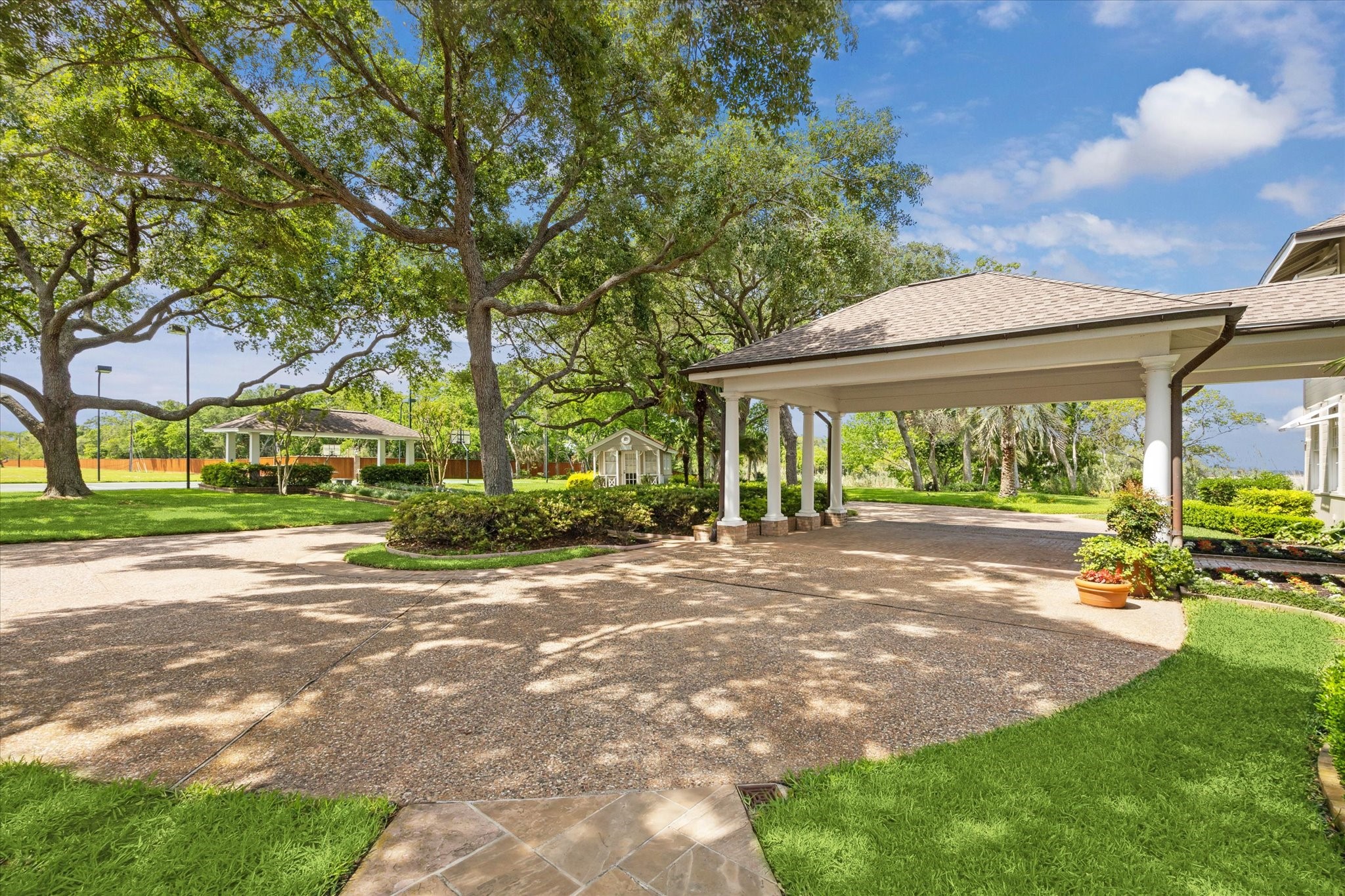 102 South R Street La Porte, TX 77571 - Photo 39 of 43 Across from the main residence, discover the "Doll House," a charming structure complemented by a lit tennis court, basketball court, and covered pavilion, offering a variety of recreational options and elegant outdoor living