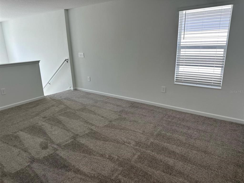 417 Cedar Key Street Davenport, FL 33837 - Photo 14 of 58 an empty room with windows