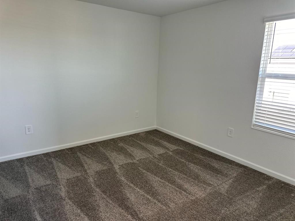 417 Cedar Key Street Davenport, FL 33837 - Photo 19 of 58 an empty room with a window