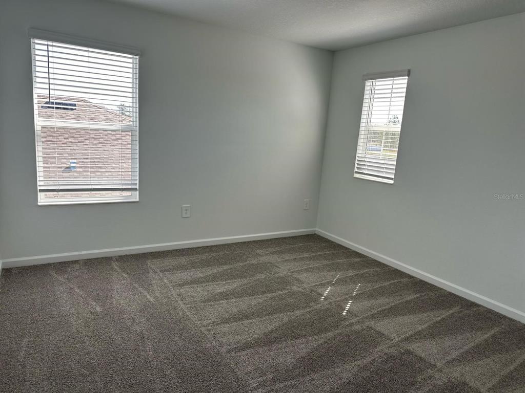 417 Cedar Key Street Davenport, FL 33837 - Photo 25 of 58 an empty room with a window