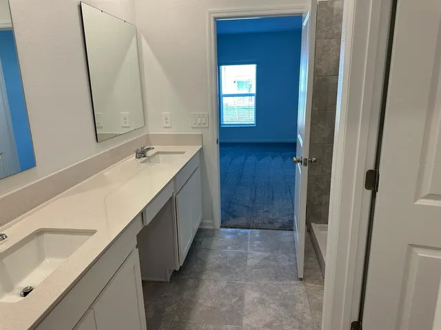 a kitchen with stainless steel appliances granite countertop a refrigerator a stove a sink and a microwave