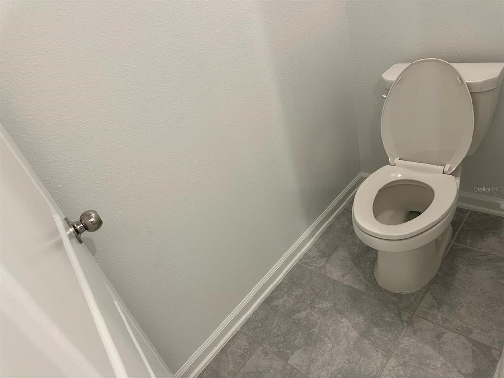 417 Cedar Key Street Davenport, FL 33837 - Photo 36 of 58 a bathroom with a toilet and a sink