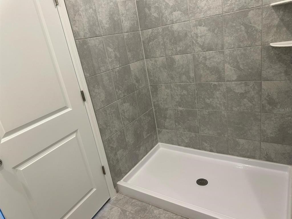 417 Cedar Key Street Davenport, FL 33837 - Photo 37 of 58 a bathroom with a tub