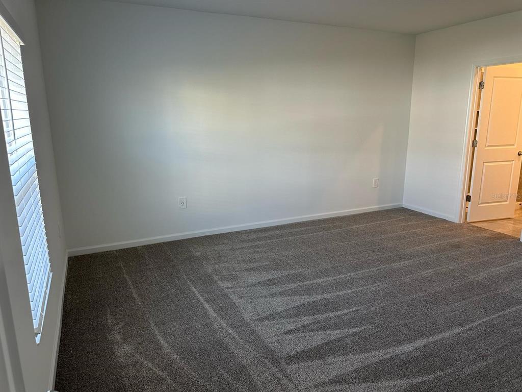 417 Cedar Key Street Davenport, FL 33837 - Photo 39 of 58 an empty room with windows