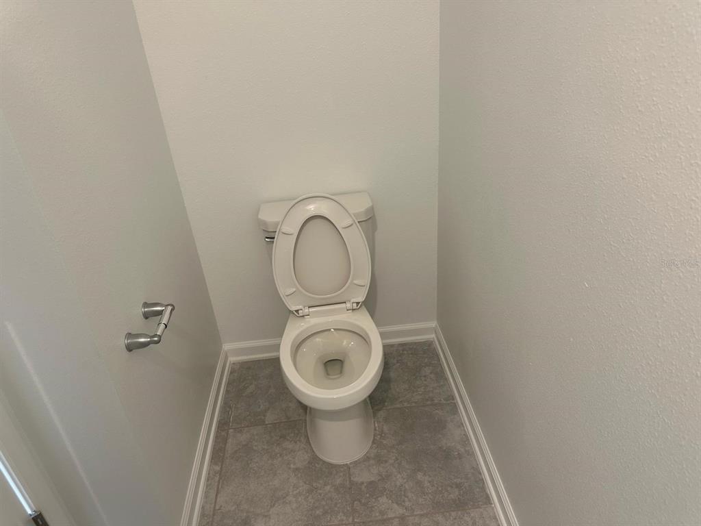 417 Cedar Key Street Davenport, FL 33837 - Photo 45 of 58 a close view of a toilet in a bathroom