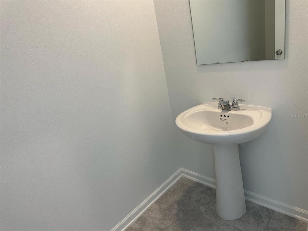 417 Cedar Key Street Davenport, FL 33837 - Photo 46 of 58 a bathroom with a sink and a mirror