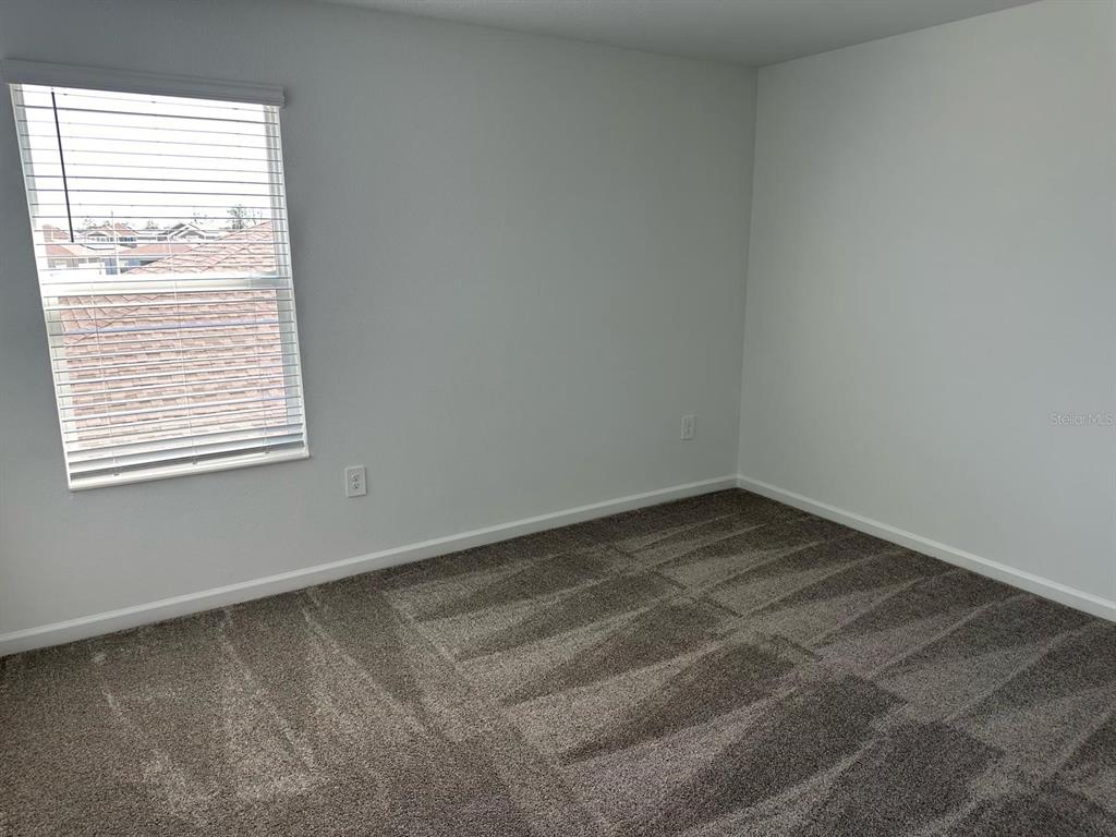 417 Cedar Key Street Davenport, FL 33837 - Photo 51 of 58 an empty room with a window