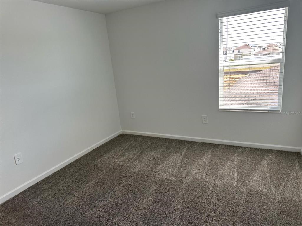 417 Cedar Key Street Davenport, FL 33837 - Photo 54 of 58 an empty room with a window