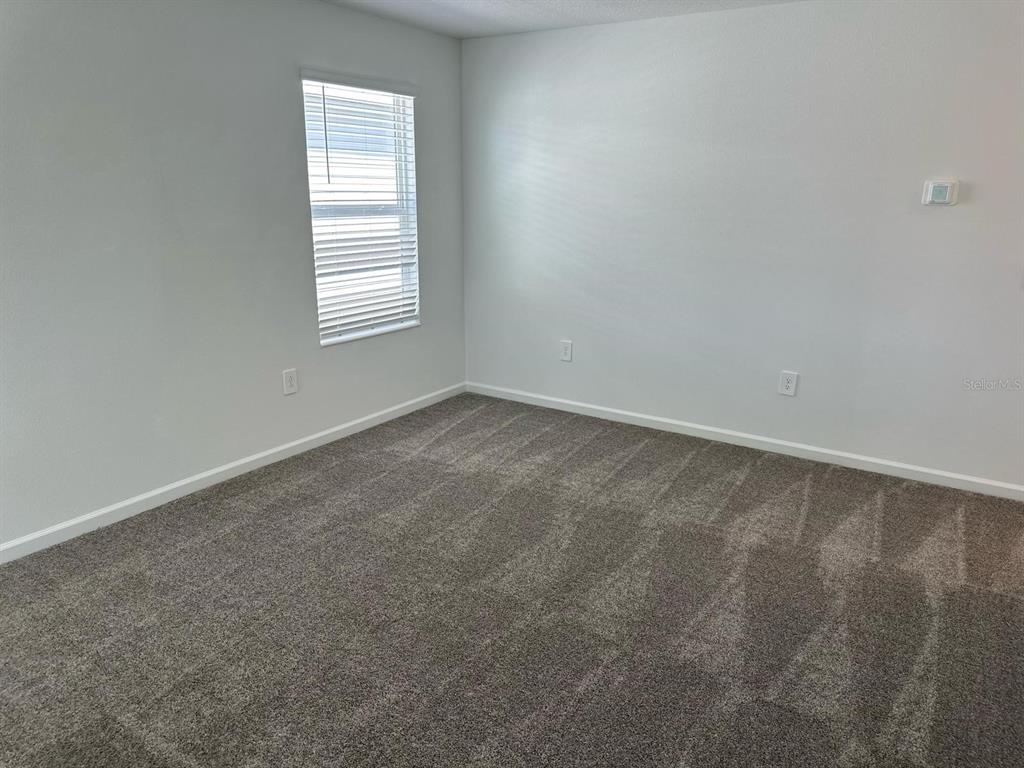 417 Cedar Key Street Davenport, FL 33837 - Photo 57 of 58 an empty room with windows