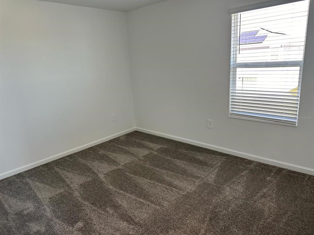 417 Cedar Key Street Davenport, FL 33837 - Photo 6 of 58 an empty room with a window