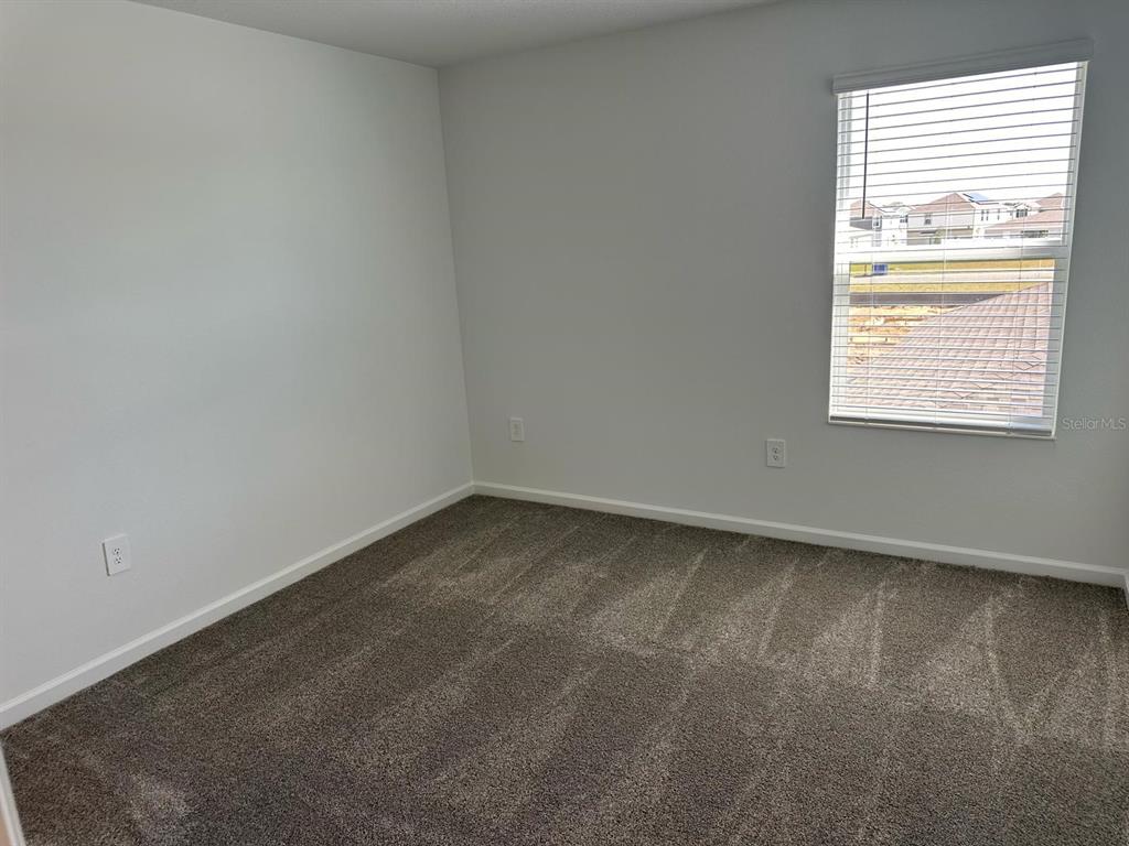 417 Cedar Key Street Davenport, FL 33837 - Photo 9 of 58 an empty room with a window