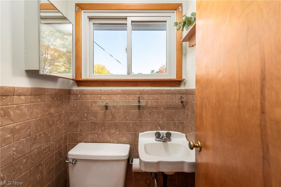 2151 Lester Road Valley City, OH 44280 - Photo 7 of 24 Bathroom with sink, toilet, and tile walls