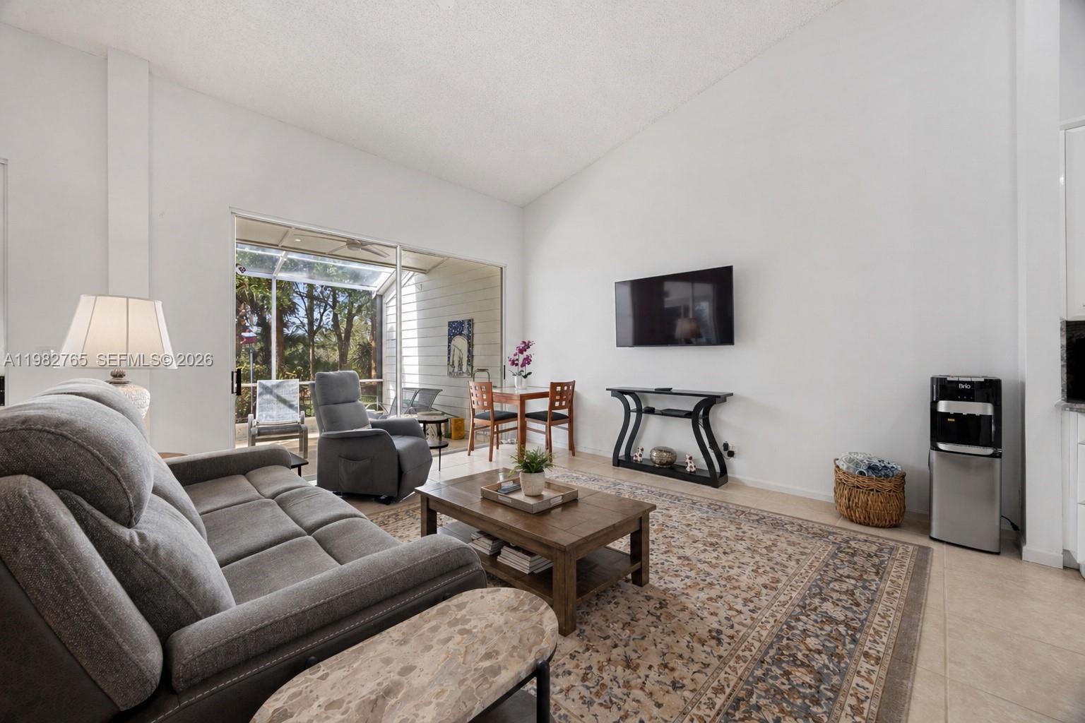 8962 Southeast Riverfront Terrace Jupiter, FL 33469 - Photo 5 of 20 a living room with furniture and a flat screen tv