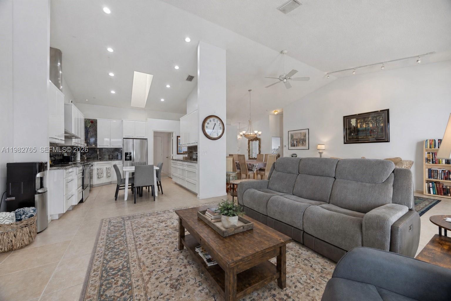 8962 Southeast Riverfront Terrace Jupiter, FL 33469 - Photo 6 of 20 a living room with furniture kitchen view and a table