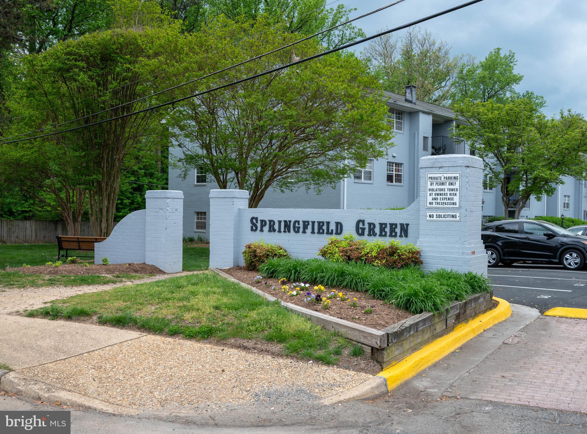 7097 Spring Garden Drive, Unit 101 Springfield, VA 22150 - Photo 14 of 17 a front view of a house with garden