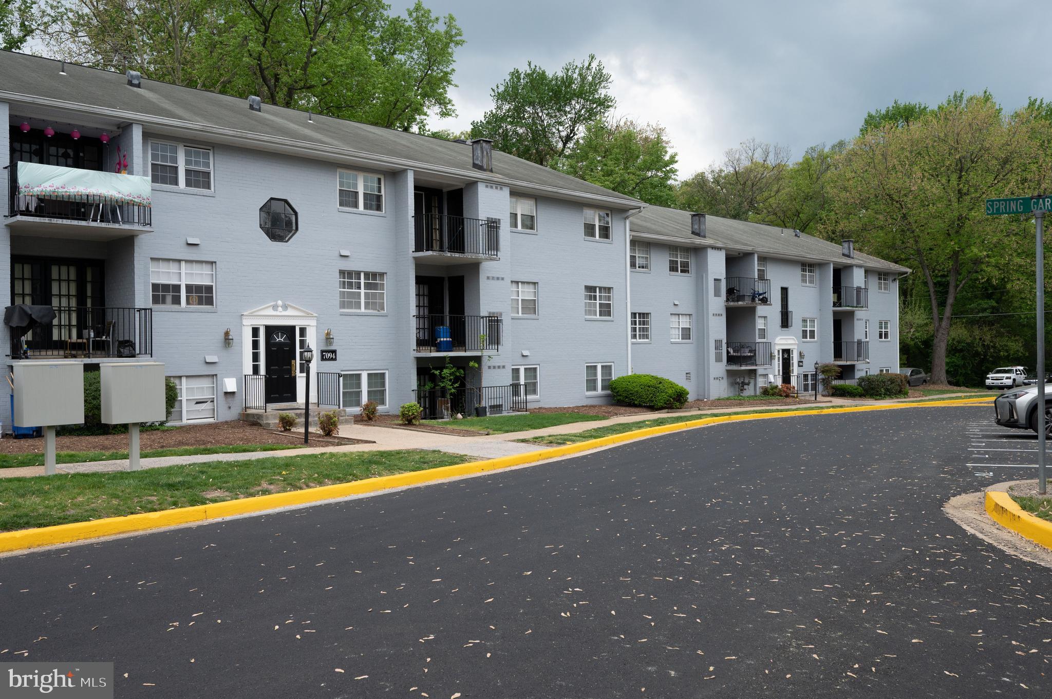 7097 Spring Garden Drive, Unit 101 Springfield, VA 22150 - Photo 15 of 17 a view of a house with swimming pool and a yard
