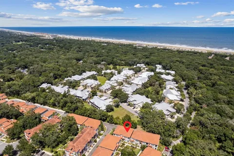 a street sign on a sidewalk next to a road