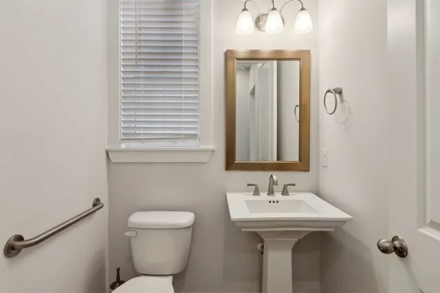 a bedroom with a large bed couch and a window