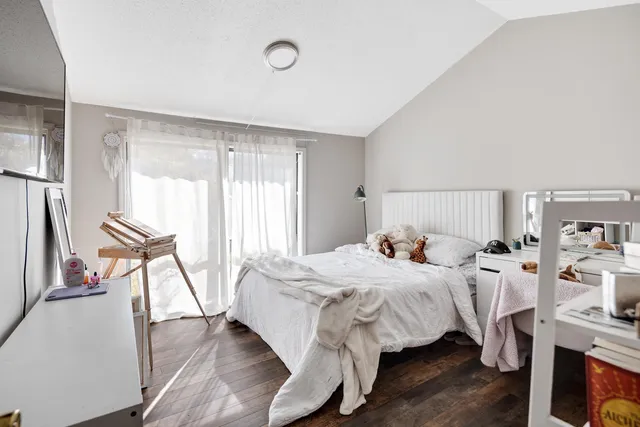 a bedroom with a bed and a window